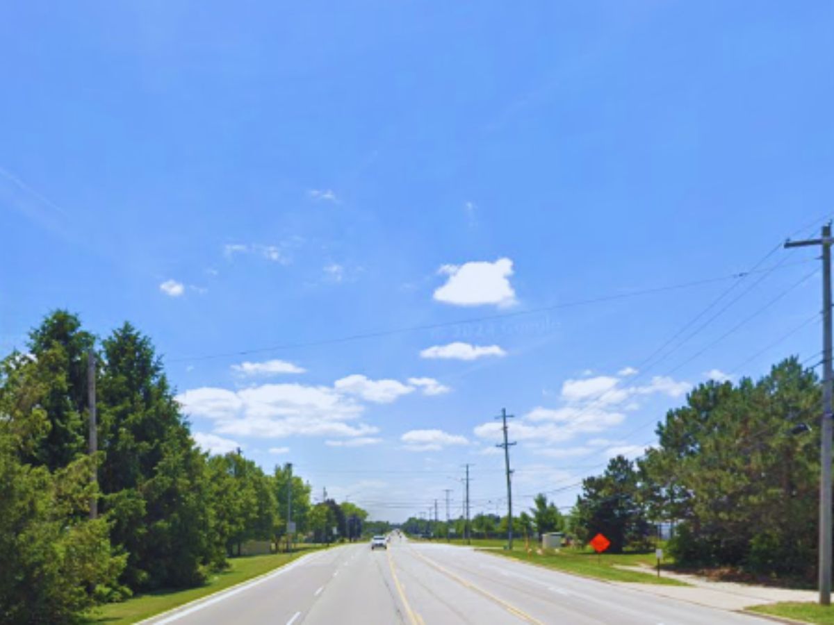 A wide, empty road in Tipp City, OH under a clear blue sky. Trees and power lines line the sides near 4463 S Co Rd 25A.