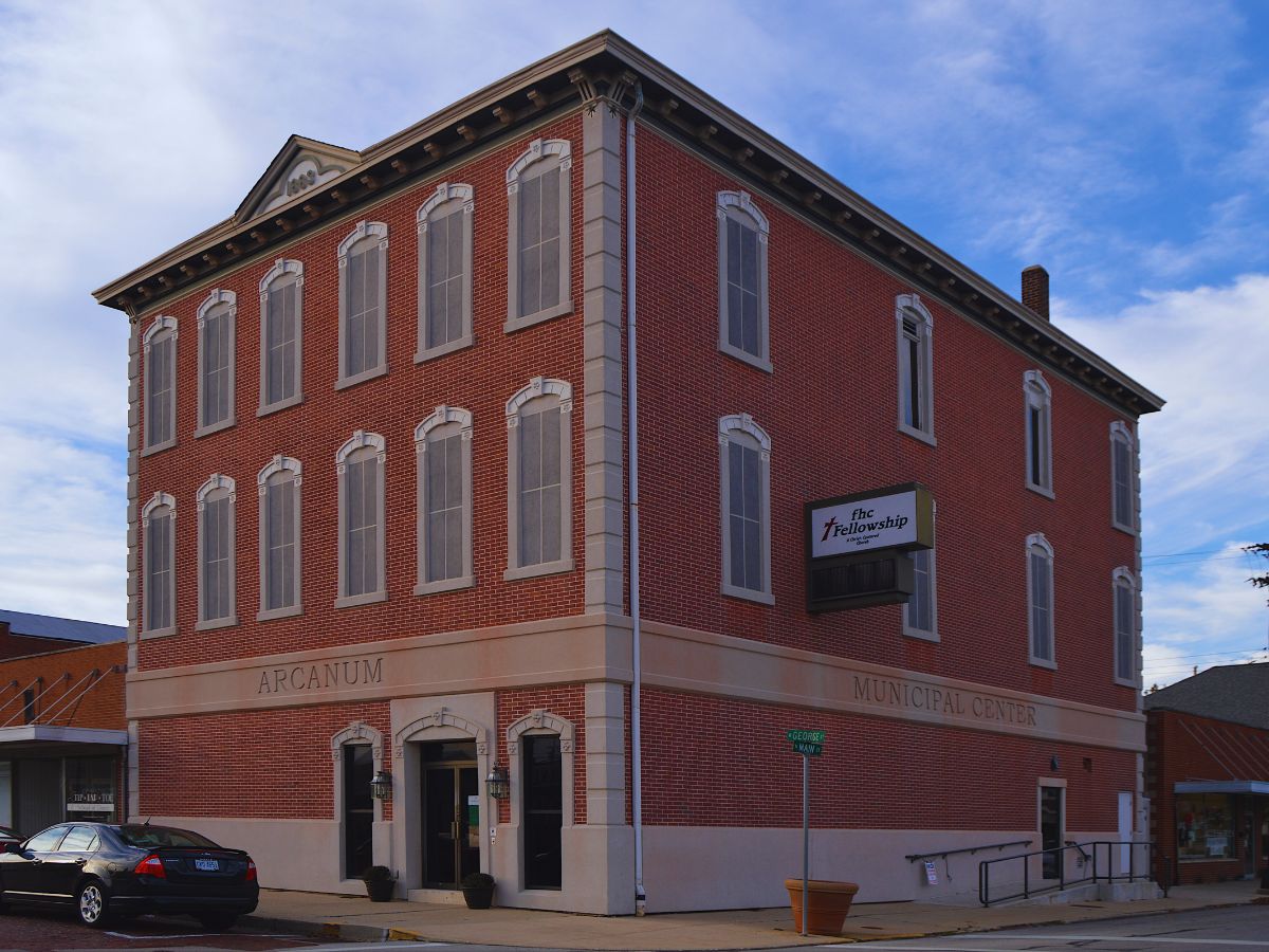 Three-story brick building with arched windows, labeled 