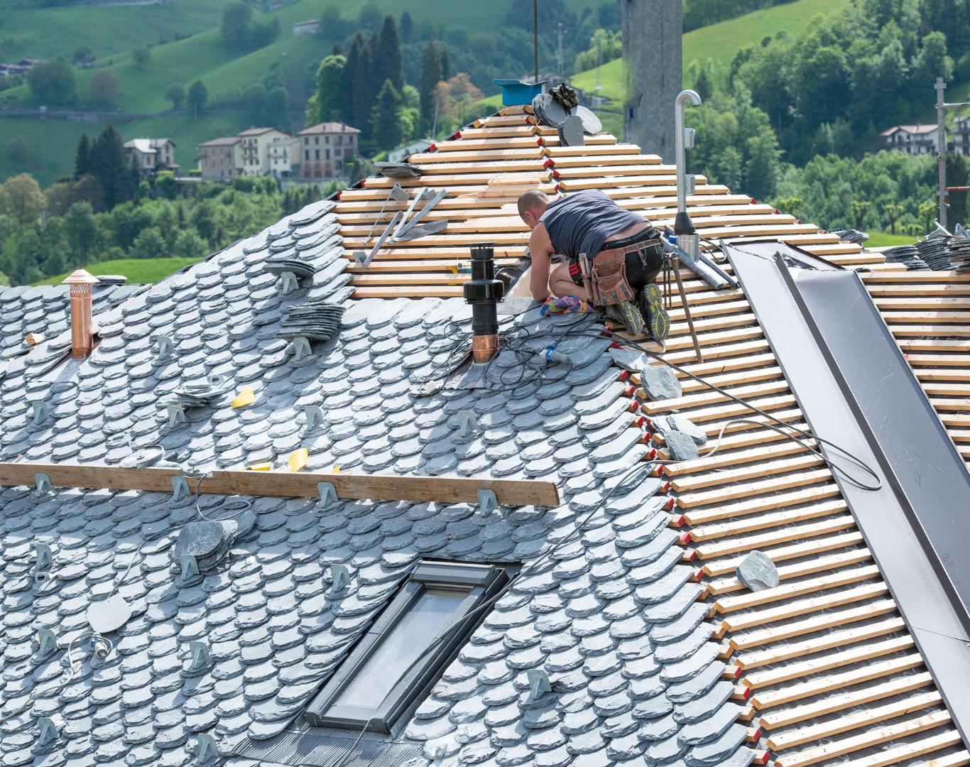 A worker from All-Side Roofing installs shingles, surrounded by tools, under a scenic countryside backdrop.