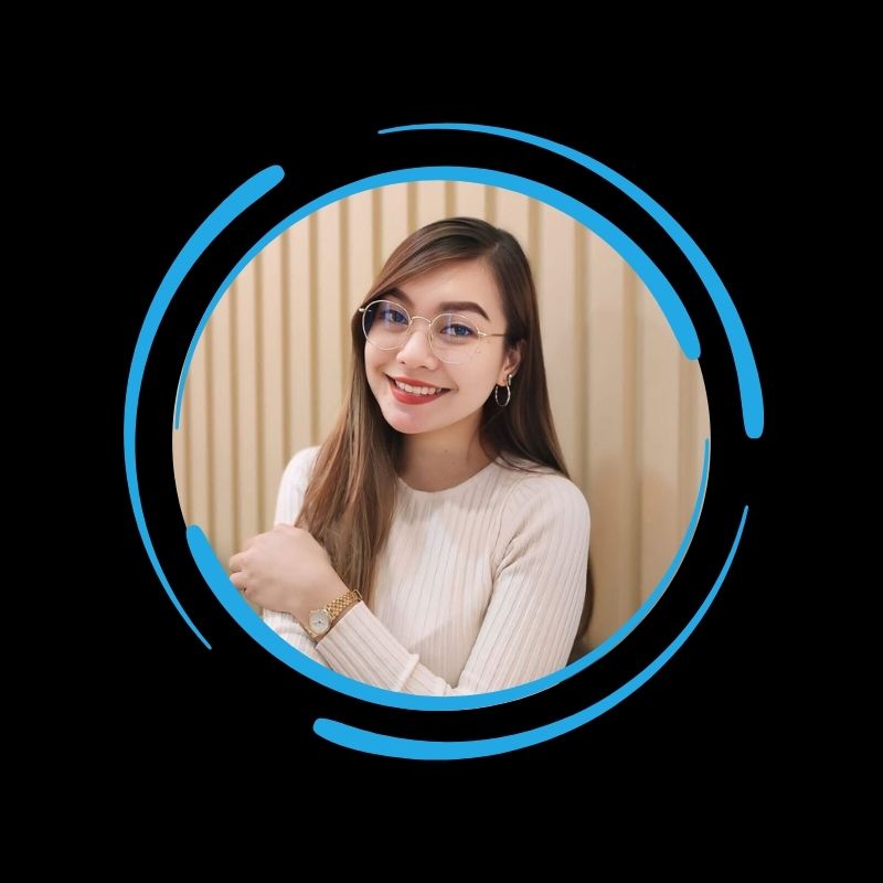 A woman wearing glasses and a white sweater smiles in front of a wooden panel, framed by blue graphics—All-Side roofing details are all about quality.