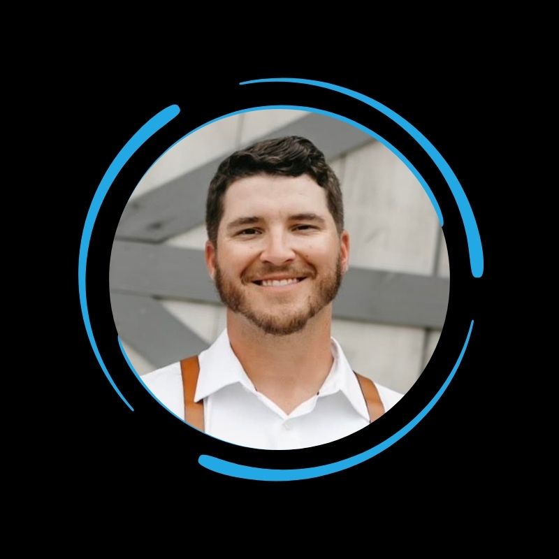 A man with short dark hair and a beard smiles at the camera, representing All-Side Roofing, framed by blue circular graphics.