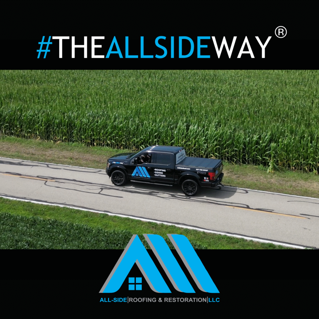 A black pickup with All-Side Roofing & Restoration LLC branding drives near a cornfield, offering expert roof repair in Springboro, OH.