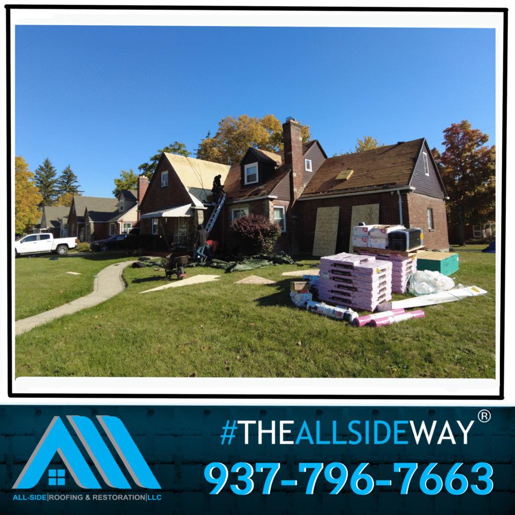 Workers repair a roof in Vandalia, OH, with roofing materials on the lawn and All-Side Roofing branding under a clear blue sky.