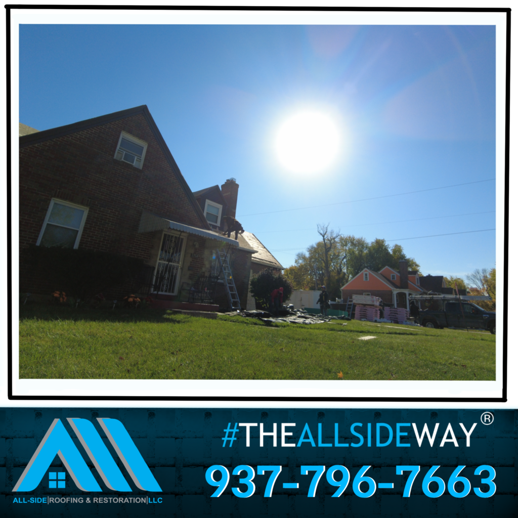 A brick house under a bright sun in Huber Heights, OH with roof replacement materials on the lawn; All-Side Roofing & Restoration contact info appears below.