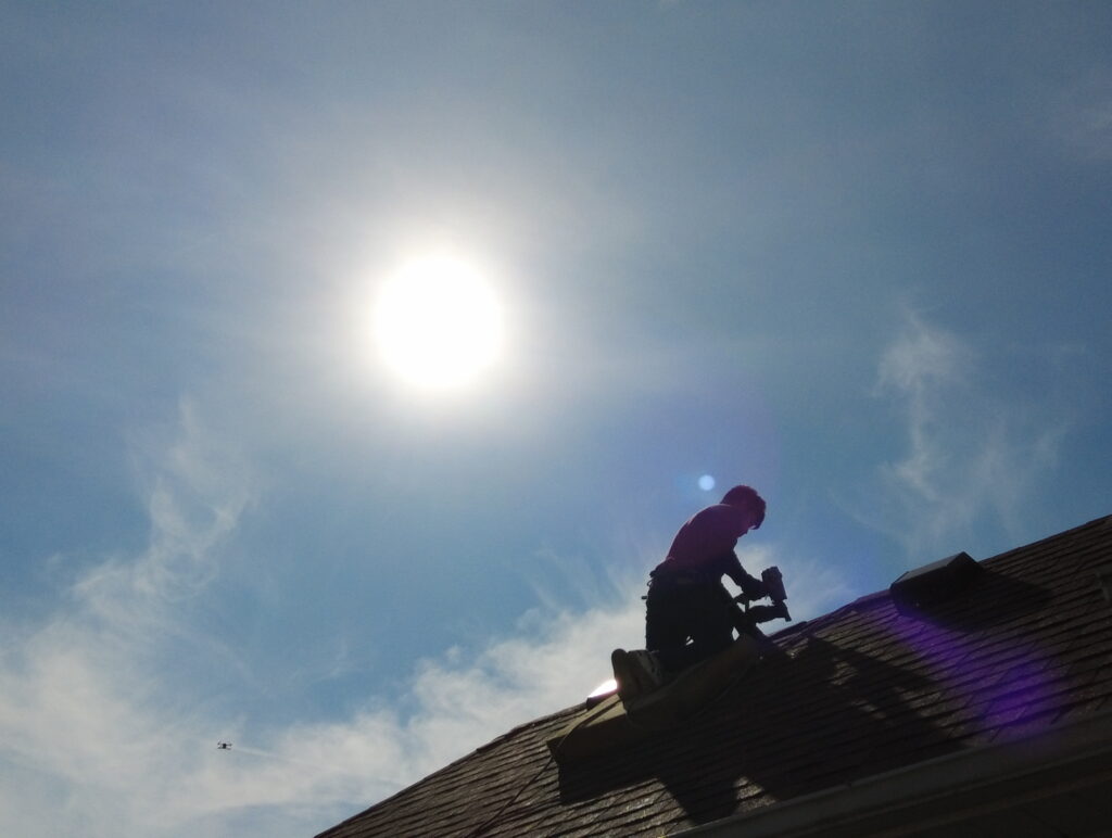 Roofing crew completing roof replacement in Hamilton, OH, on a residential property